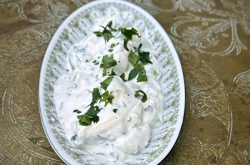 Deliciously fresh tzatziki side with Greek yogurt, cucumbers, parsley, cilantro, and garlic