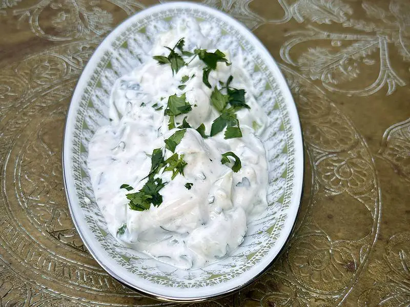 Deliciously fresh tzatziki side with Greek yogurt, cucumbers, parsley, cilantro, and garlic